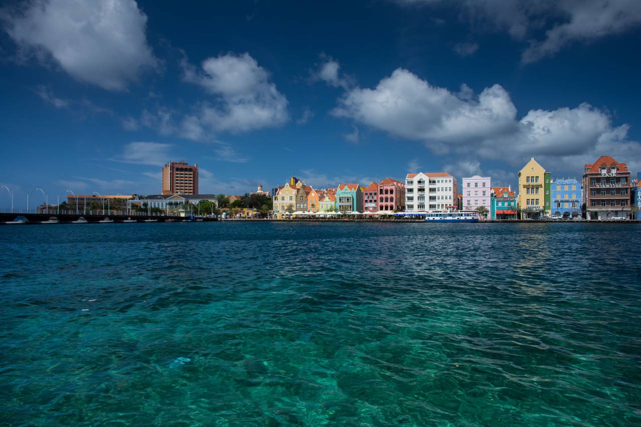 Willemstad, Curaçao, island, caribbean, buildings, architecture, skyline, colors, sky, clouds, boardwalk, dock, pier, boats, sea
, 