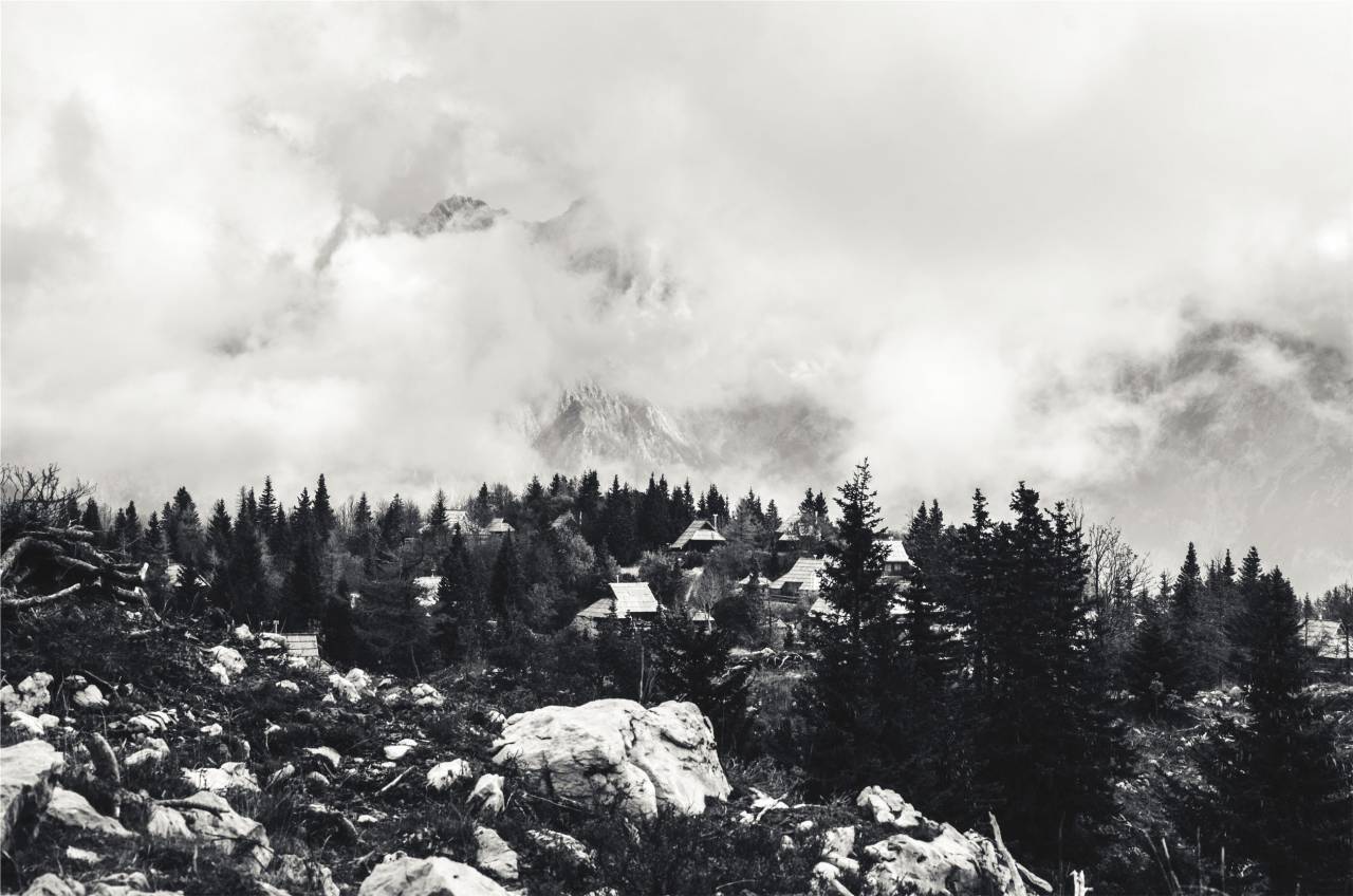 landscape, houses, rocks, boulders, trees, mountains, clouds, black and white
, 