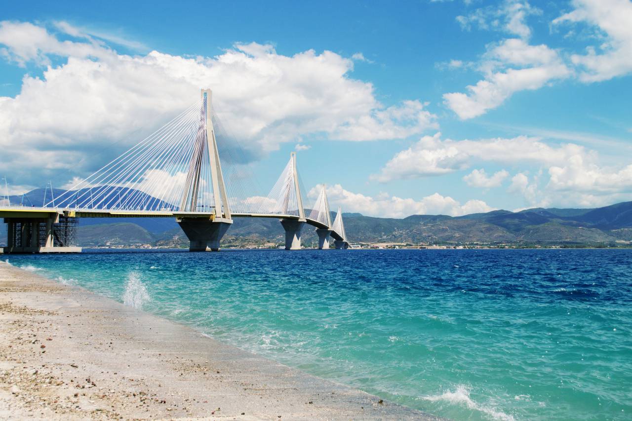 sea, ocean, blue, water, waves, nature, white, sand, beach, seashore, infrastructure, bridge, architecture, travel, outdoors, mountain, landscape, view, clouds, sky
, 