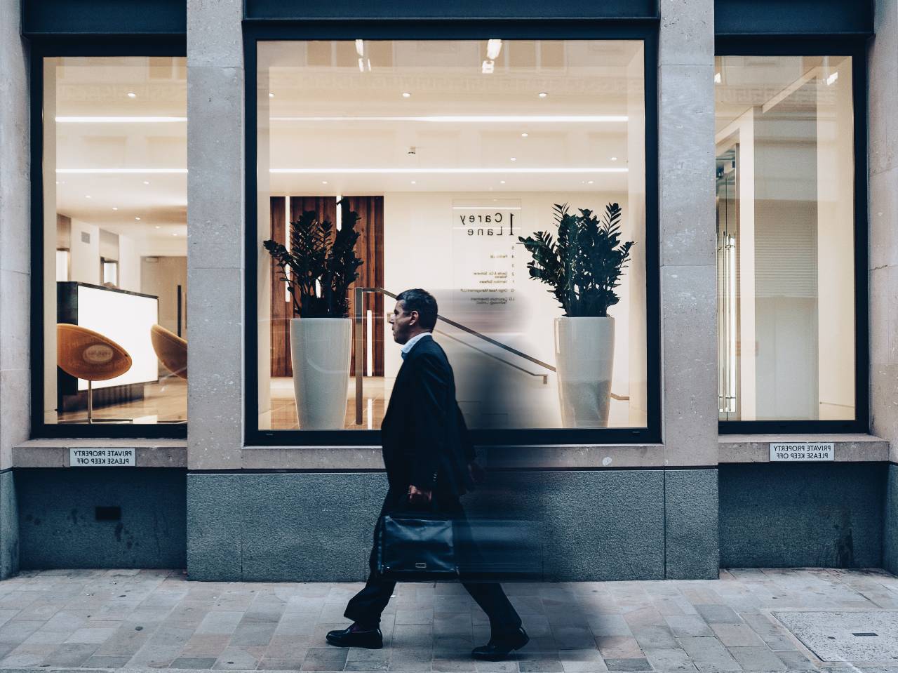 man, guy, walking, glass, window, pane, bag, shop, vase, plant, lights, chair, establishment
, 