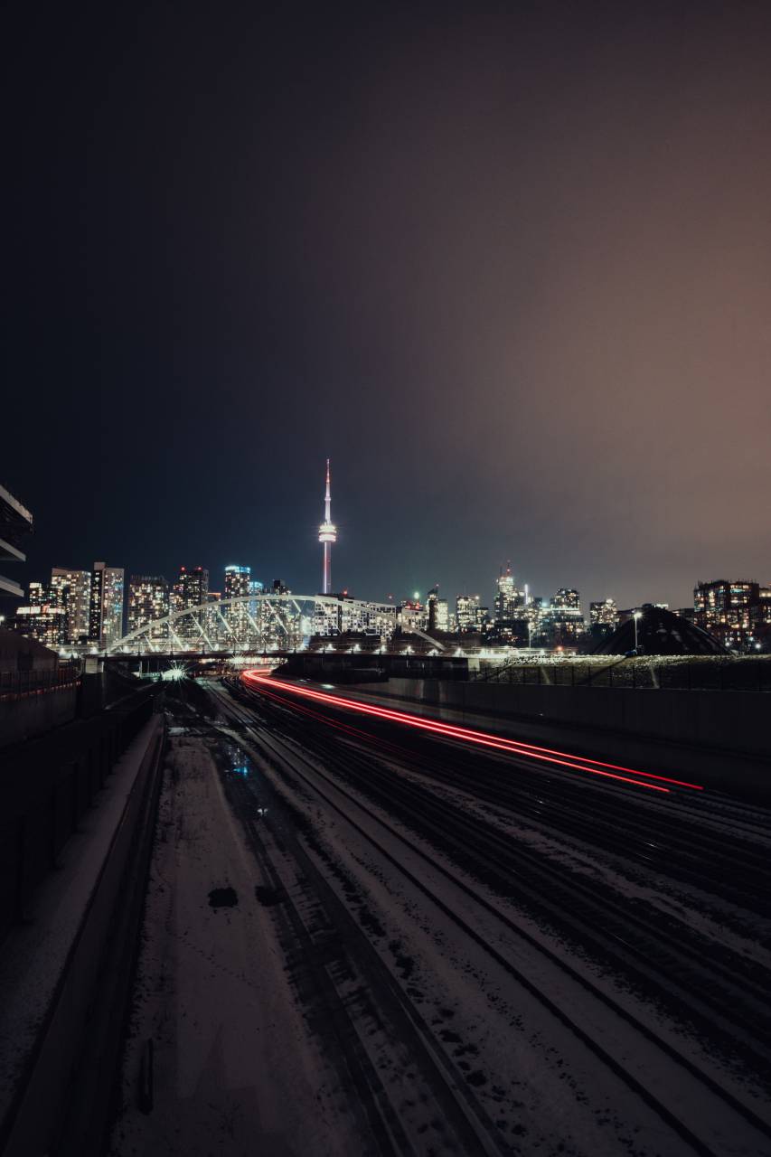 toronto;night;cityscape,night,cityscape,dusk,traffic,skyscraper,urban skyline,architecture,city life,illuminated,car,outdoors,building exterior,famous place,built structure,transportation,dark,travel,street light,blurred motion,speed, 