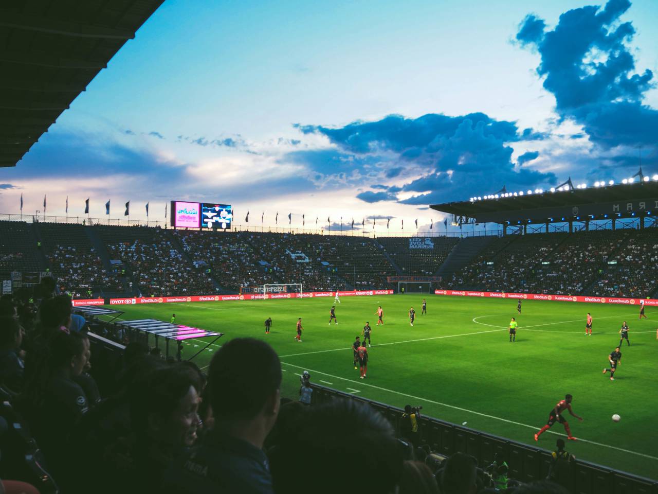 football, soccer, field, tournament, sport, game, people, crowd, men, women, players, competition, sky, clouds, dark, sunset, goal
, 