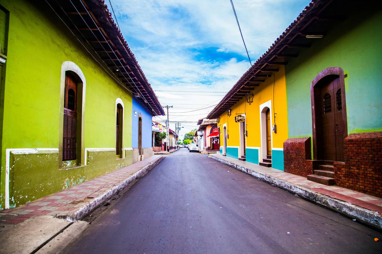 Le?n Nicaragua, street view, colonial architecture, Nicaragua city, Central America, colorful buildings, urban life, cobblestone street, historic town, local culture, everyday life, tropical city, street photography, Latin America, vibrant colors, traditional homes, travel destination, old town, colonial street, sunny day, pedestrian street, Latin lifestyle, cultural heritage, local people, rustic charm, outdoor market, architecture detail, small town vibe, travel photography, historical city, latinamerican, 