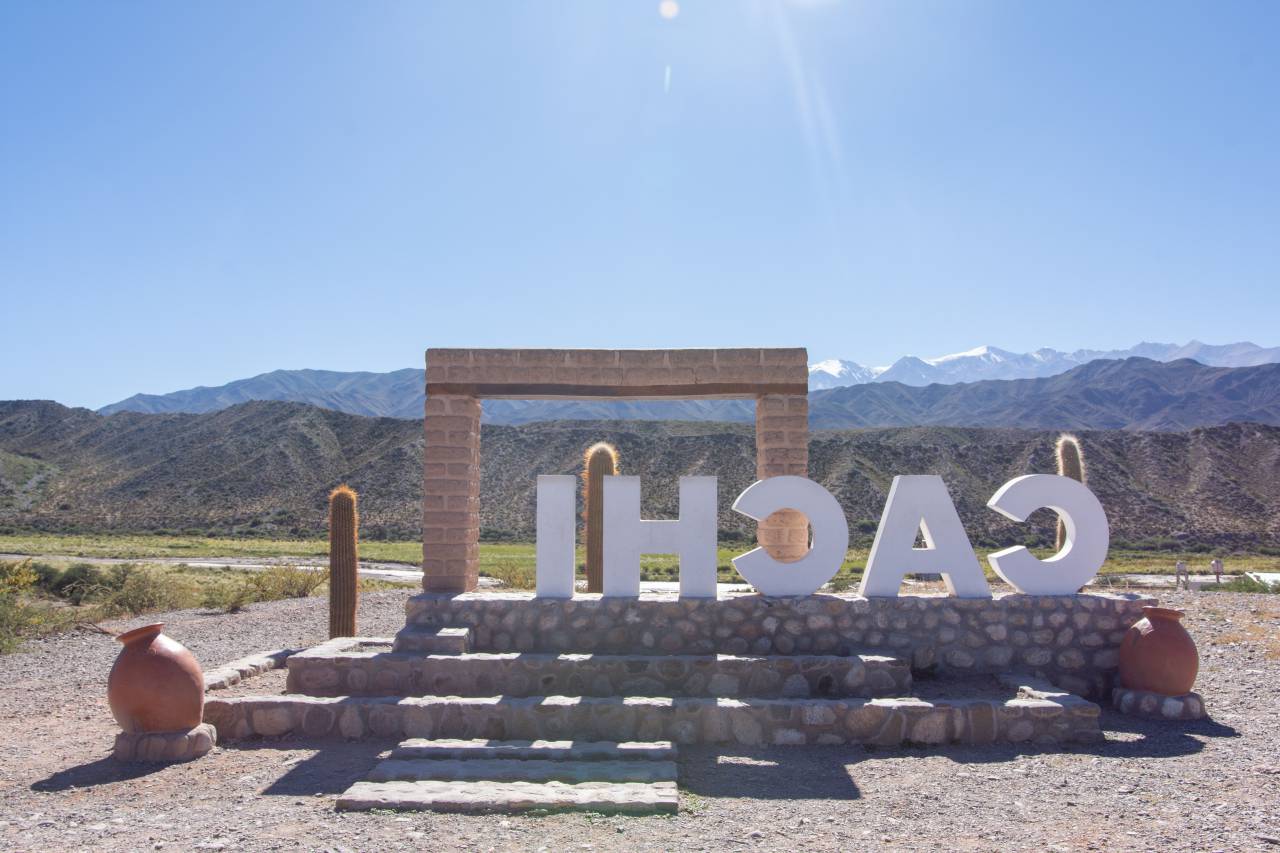 No People, Travel, Travel Destinations, Landscape, Scenery, Mountain, Famous Place, Nature, Hill, Journey, Scenics, Andes, Desert Area, Sign, Symbol, Town, Welcome Sign, mountains, blue sky, outdoor, Argentina, sunny day, Tourism, scenic view, vibrant sign, stone structure, Cactus, Art, Exploration, culture, historical town, high altitude, desert, Tranquility, Adventure, Hiking, pristine, architectural detail, regional charm, visitor attraction, Beauty, travel destination, iconic location, Summer, Relaxation, panoramic view, Discovery, Community, local art, heritage, traditional crafts, Cachi, latinamerican, 