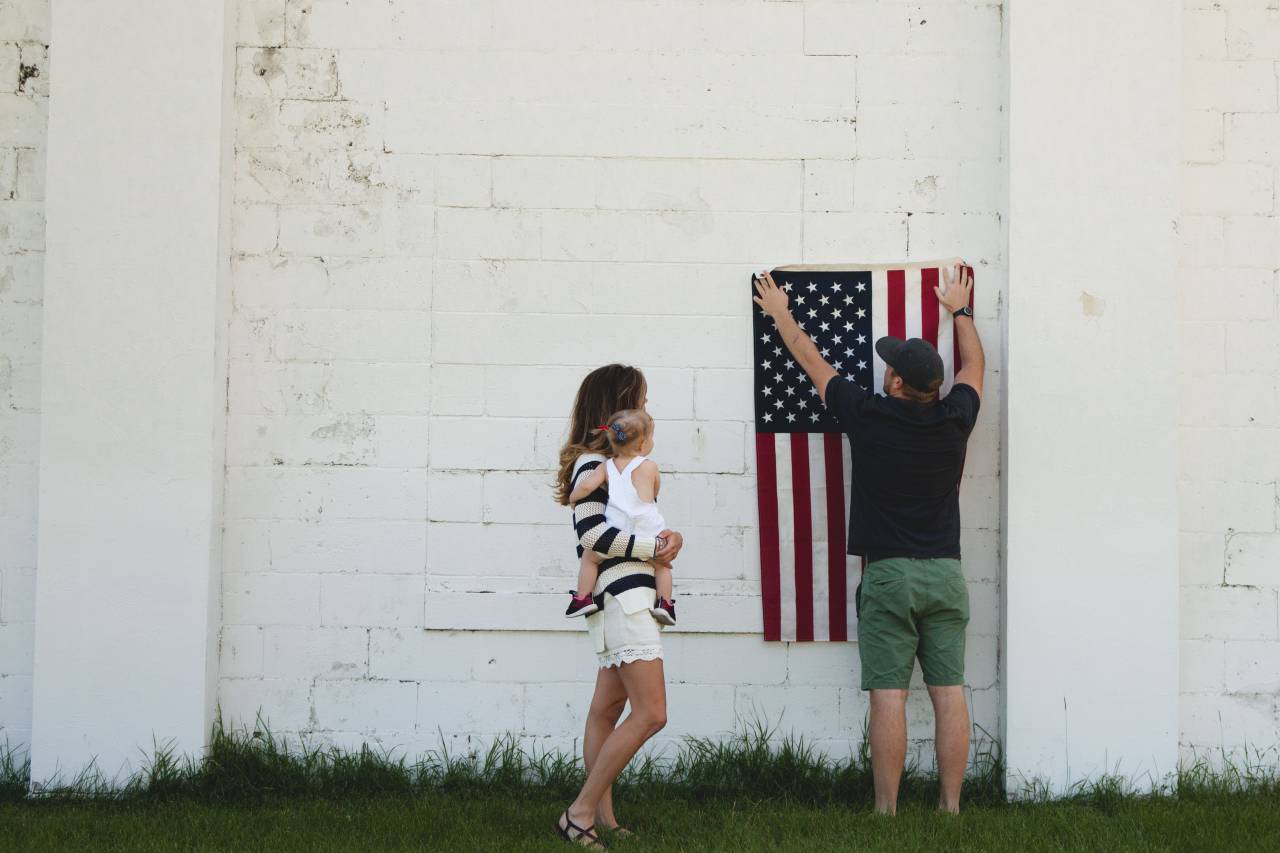 family, people, parent, mother, mom, baby, kid, child, cute, sweet, father, dad, flag, grass, wall, white
, 