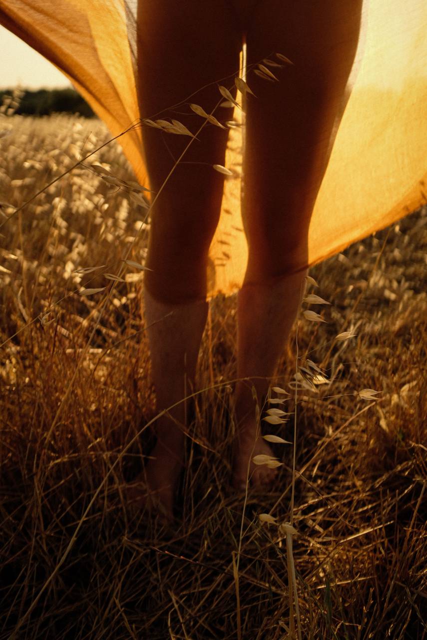 woman;handkerchief;sunset;outdoors,nature,outdoors,human leg,summer,women,one person,sunset,adult,grass,lifestyles,sunlight,meadow,close-up,relaxation,sun,human foot,rural scene, 