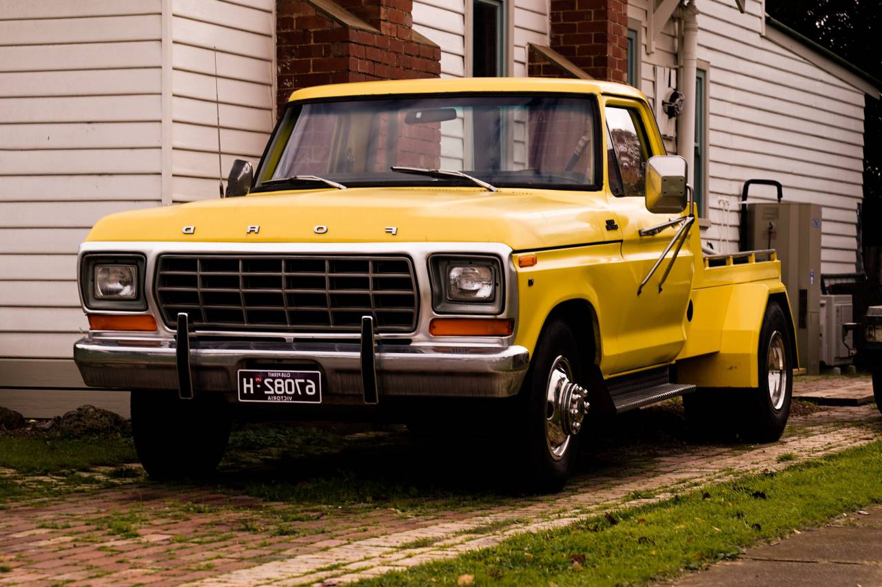 truck,transportation,car,land vehicle,mode of transport,outdoors,yellow,speed,bus,machinery,traffic,travel,chrome,bumper,truck, 