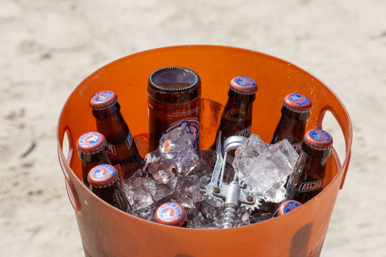 alcohol, cold, ice, beach, beer, refreshment, drink, beverage, bucket, bottle, glass, sea, summer, blue, sky, ocean, background, water, lager, vacation, sand, sun, cool, bar, drop, clouds, condensation, closeup, white, tropical, close, liquid, isolated, fresh, table, ale, bubbles, full, party, cube, brown, transparent, macro, nature, pilsner, summertime, celebration, cooler, 
