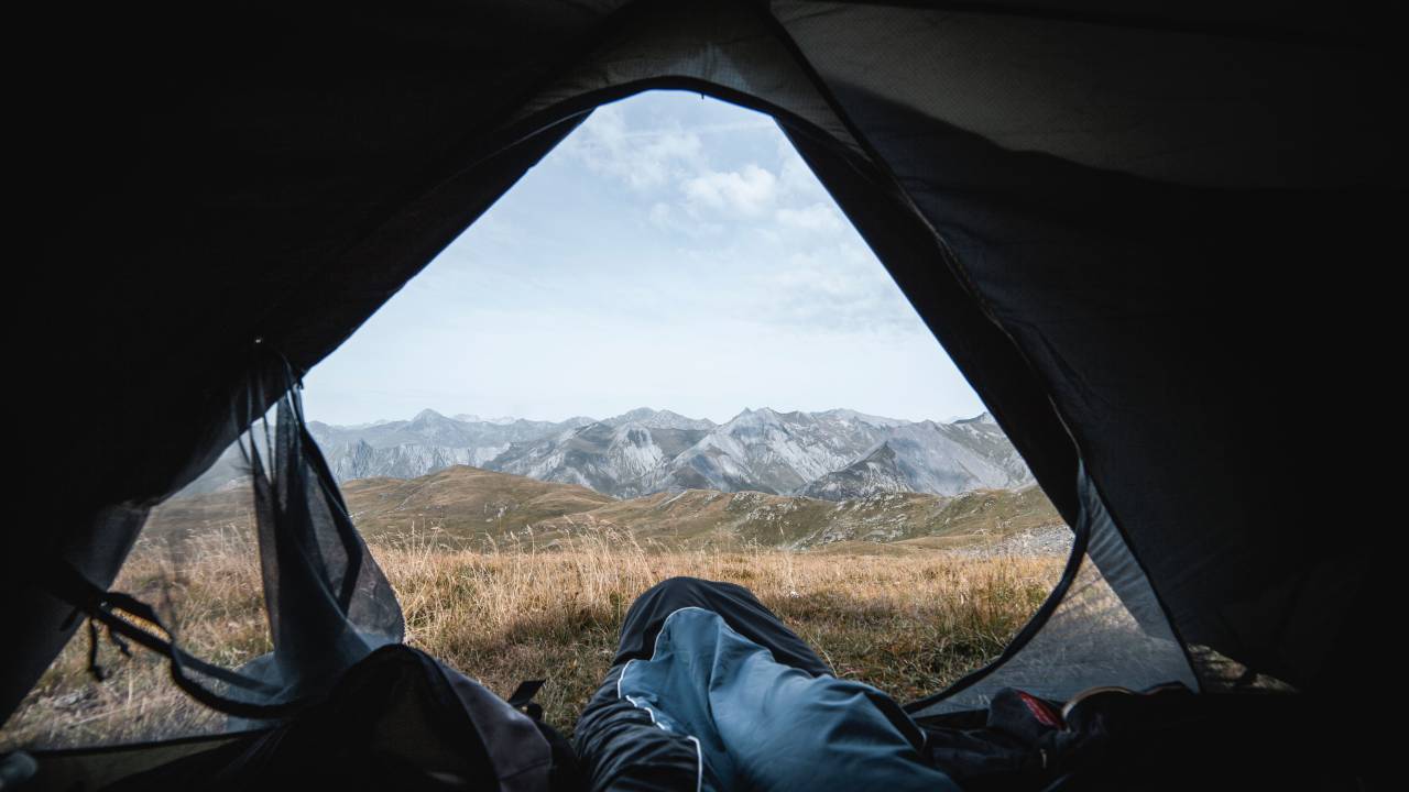 tent;mountains,tent,camping,hiking,adventure,nature,outdoors,mountain,travel,vacations,backpack,men,tourist,leisure activity,landscape,one person,relaxation,adult,mountain peak,recreational pursuit,summer,sport,resting,exploration,extreme sports,lifestyles,freedom, 
