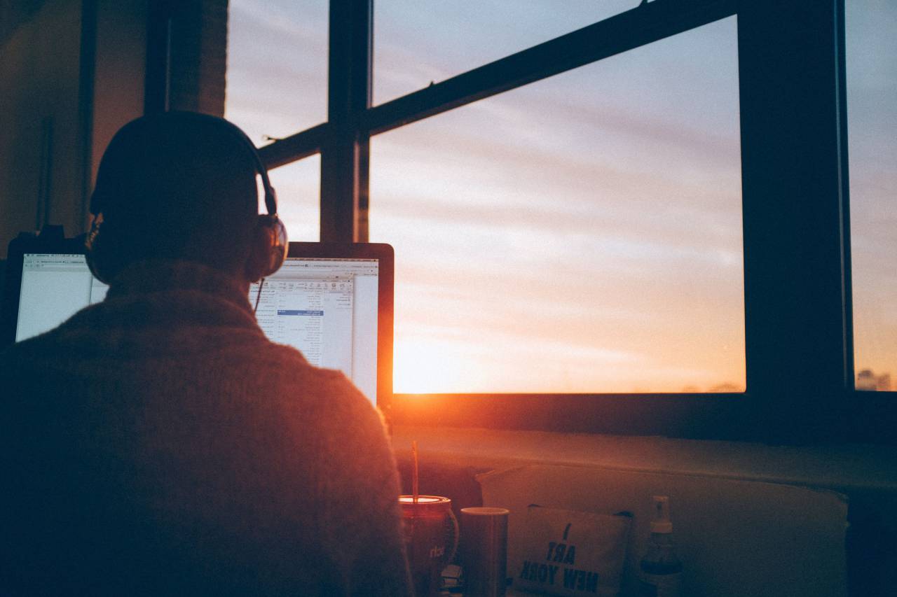 man;working;computer,men,working,one person,window,sunset,businessman,adult,back lit,males,occupation,office,business person,indoors,sun,sunlight,silhouette,looking,dusk,table,sitting, 
