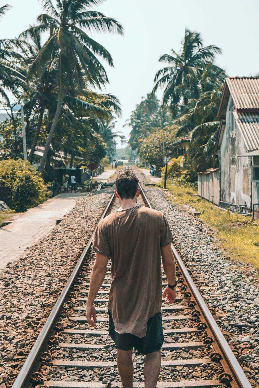 man, walking, tracks, train, transport, alone, summer, vacation, holiday, travel, palm tree, house, building
, 