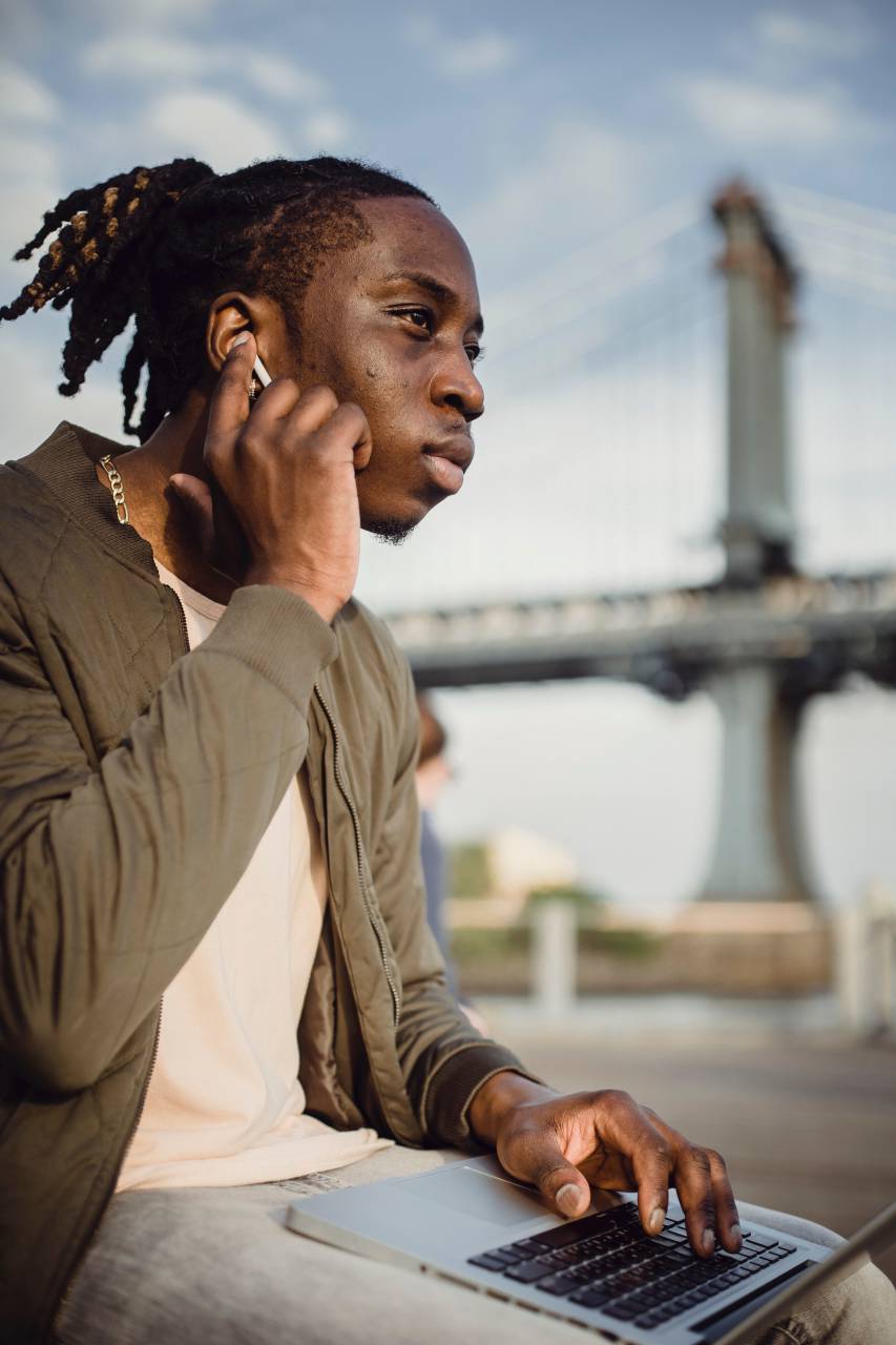 Afroamerican, Young, Man, Laptop, Listening, Music, Wireless, Headphones, Technology, Relaxed, Casual, Modern, Focused, Youthful, Entertainment, Outdoors, 