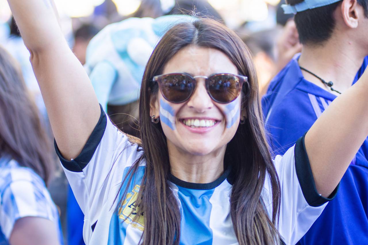 Argentine, Fan, Celebration, Victory, Soccer, Crowd, Passion, Pride, Excitement, Football, Euphoria, Supporters, Energy, Stadium, Fandom, Teamwork, Cheers, Flag, Enthusiasm, Spirit, Joy, Female, Triumph, Unity, Flags, Nationalism, Win, Sports, Cheer, Team, Festival, 2022, t-shirt, shirt, 