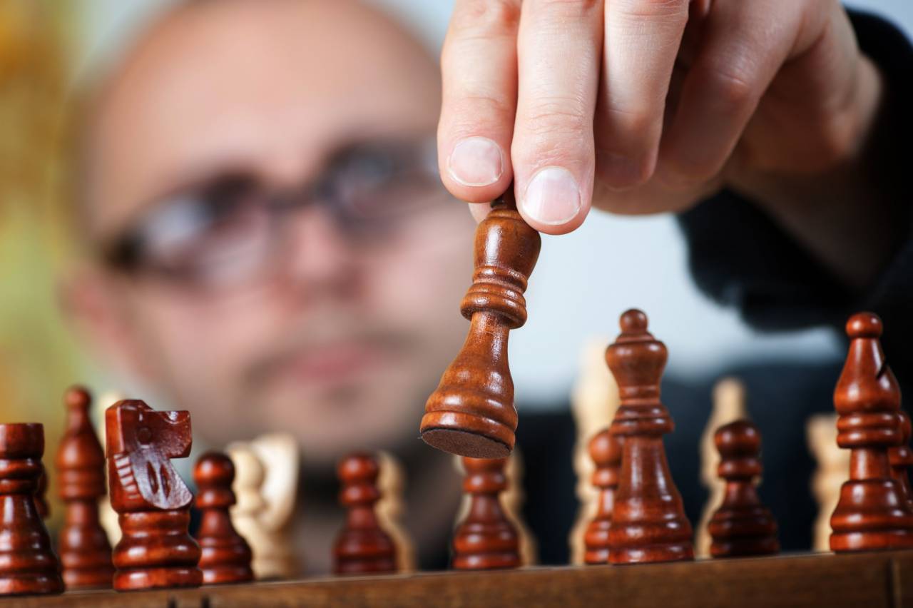 chess, game, strategy, intelligence, competition, man, concept, business, win, play, leisure, board, businessman, challenge, move, king, strategic, table, battle, leadership, fight, hand, player, queen, checkmate, piece, people, white, match, male, winner, chessboard, success, concentration, think, person, pawn, thinking, power, background, planning, lifestyle, wooden, conflict, young, knight, adult, victory, black, playing, 