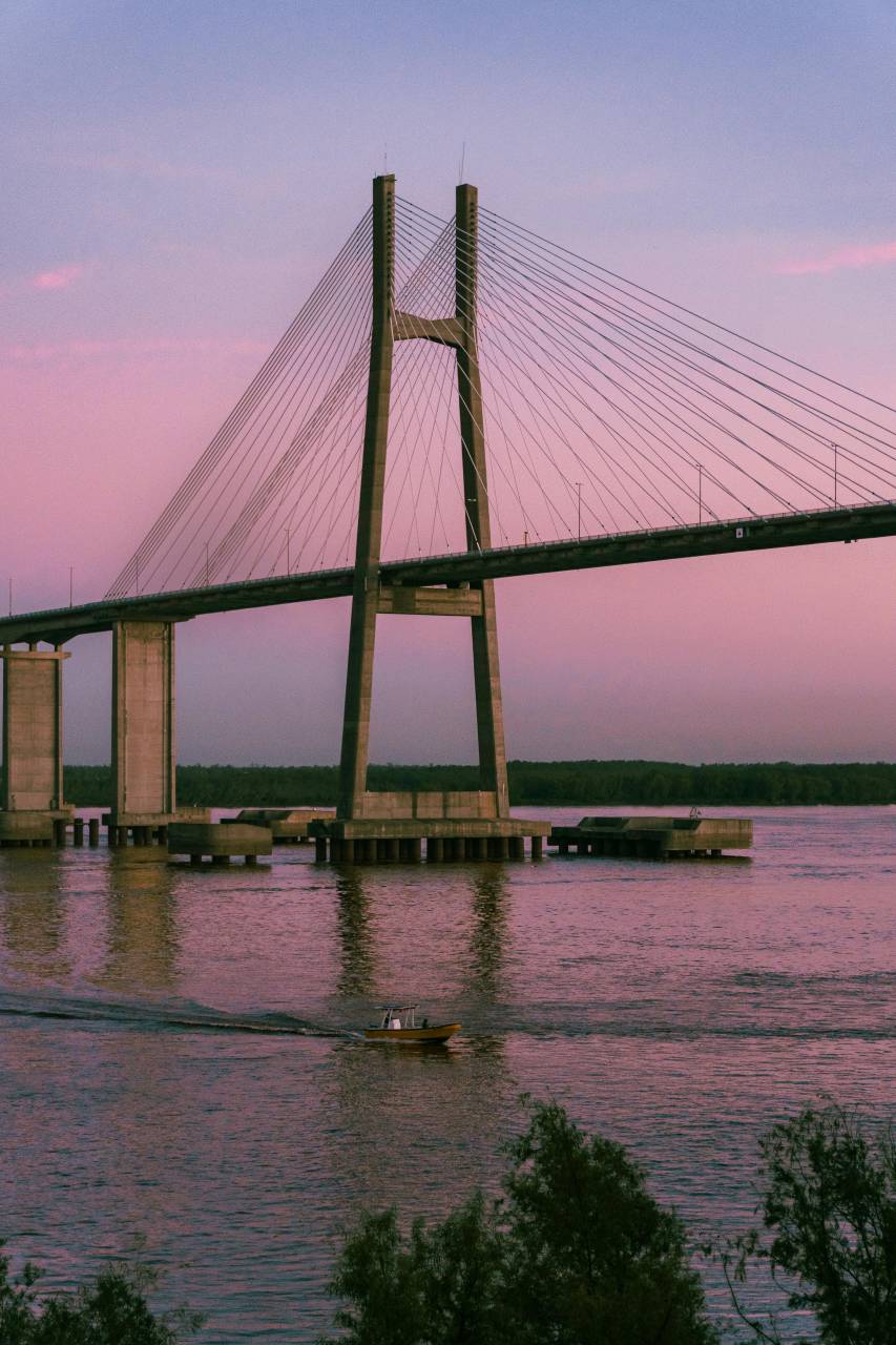 Rosario Victoria Bridge, suspension bridge, Rosario Argentina, Paran? River, iconic bridge, Argentine landmark, urban infrastructure, river crossing, modern bridge, architectural structure, South America, city skyline, transportation link, engineering marvel, bridge at sunset, cityscape, bridge lights, urban landmark, connectivity, travel Argentina, scenic view, metropolitan area, famous bridge, steel bridge, night photography, bridge silhouette, Argentina travel, waterfront, bridge architecture, landmark photography, latinamerican, 