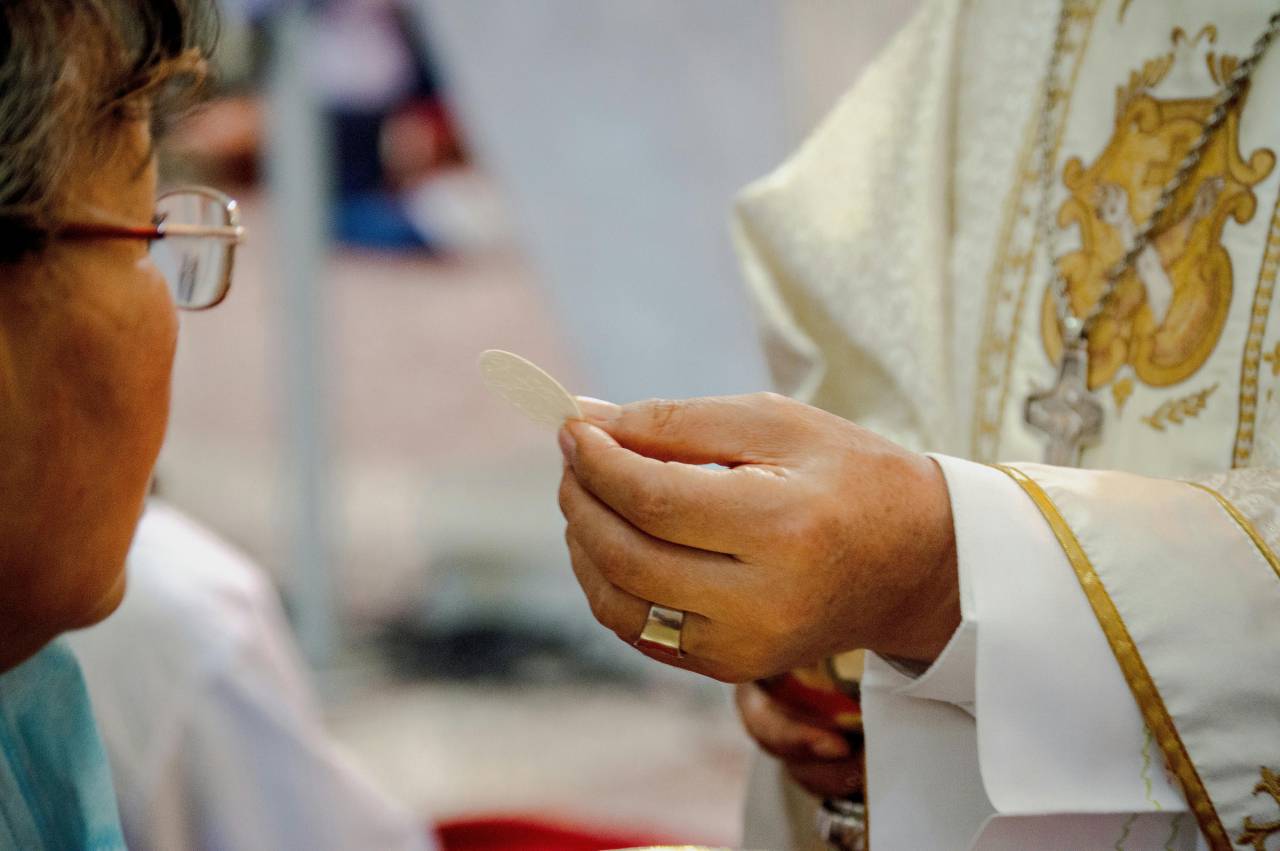 woman receiving communion, church ceremony, Guayaquil Ecuador, Catholic ritual, religious service, holy communion, faith moment, Christian worship, spiritual event, sacred tradition, church interior, Ecuador religion, Guayas province, religious practice, communion ritual, solemn moment, believer, church community, Eucharist, religious devotion, spiritual connection, Latin American church, cultural tradition, faith expression, worship service, sacred ceremony, church celebration, Christian faith, religious experience, prayer, holy sacrament, latinamerican, 