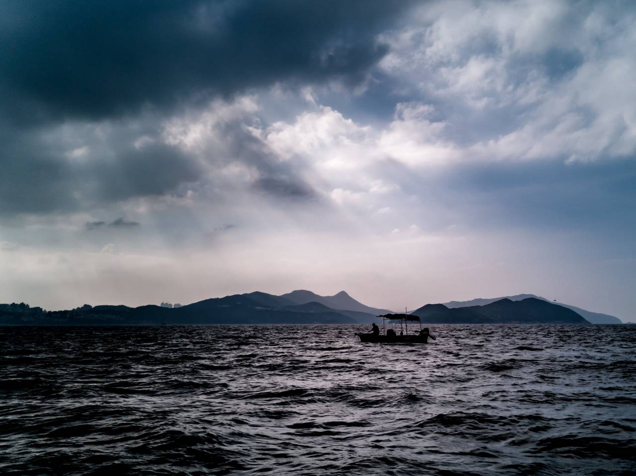 man, boat, sailing, lake, gray, clouds, sky, water, outdoor, nature, travel, calm, scenic, vessel, weather, adventure, tranquil, 