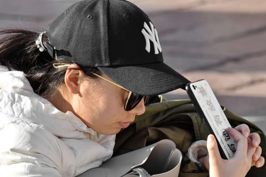 Asian, cellphone, girl, hat, side view 
