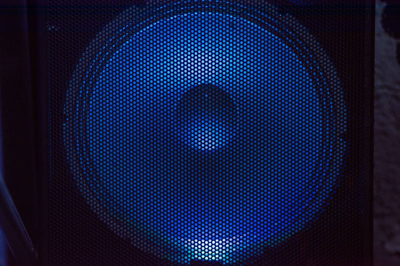 Bluetooth speaker, blue light, wireless, music, sound, technology, electronic, device, portable, gadget, connectivity, modern, innovation, entertainment, illuminated, glowing, LED, sleek, stylish, design, 