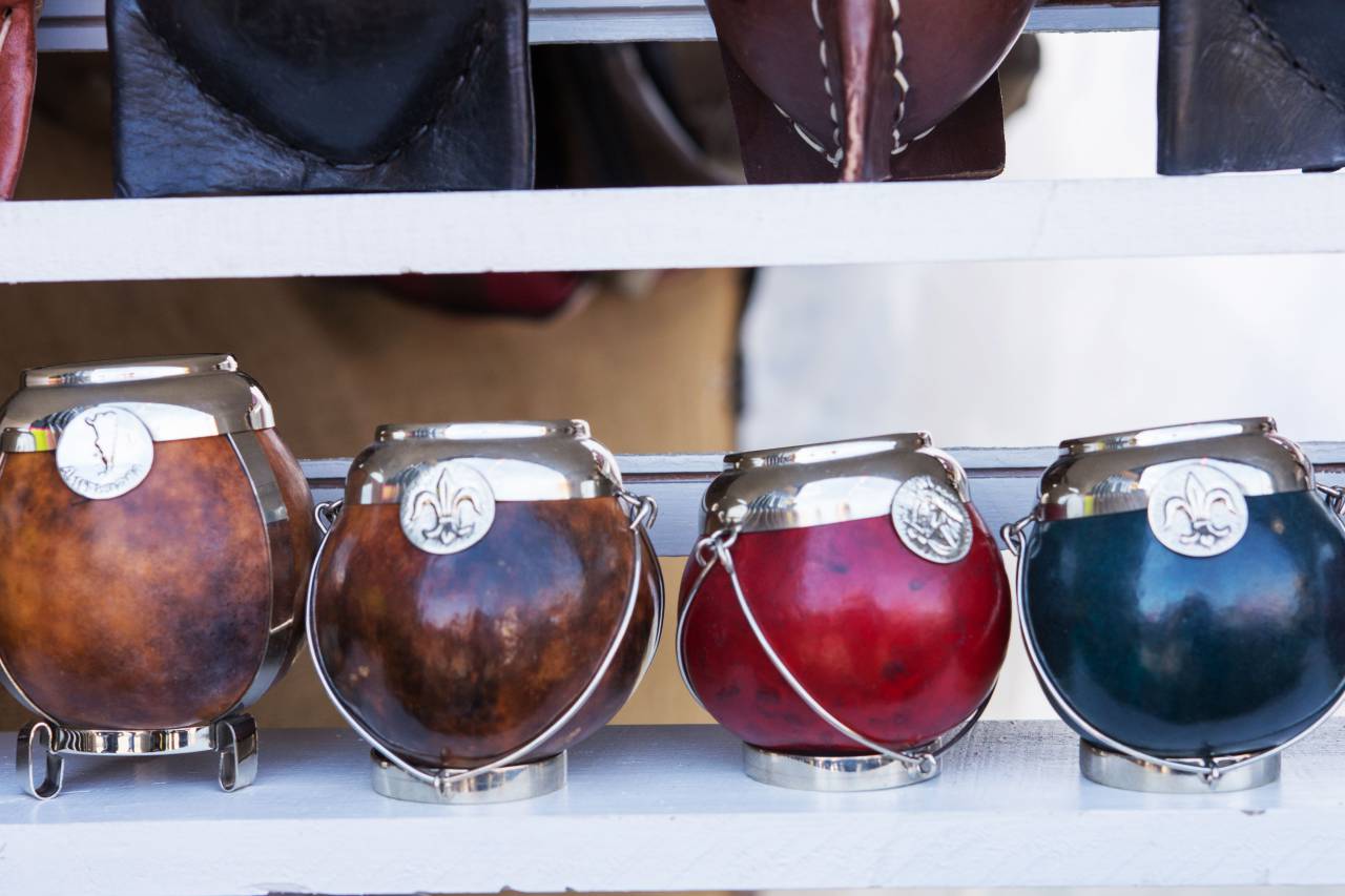 Artisan, Yerba Mate, cups, displayed, sale, market stall, handmade, traditional, South America, Argentina, Paraguay, Uruguay, beverage, tea, herbal, organic, natural, sustainable, eco-friendly, cultural, souvenir, handicraft, tourism, market, merchandising, 