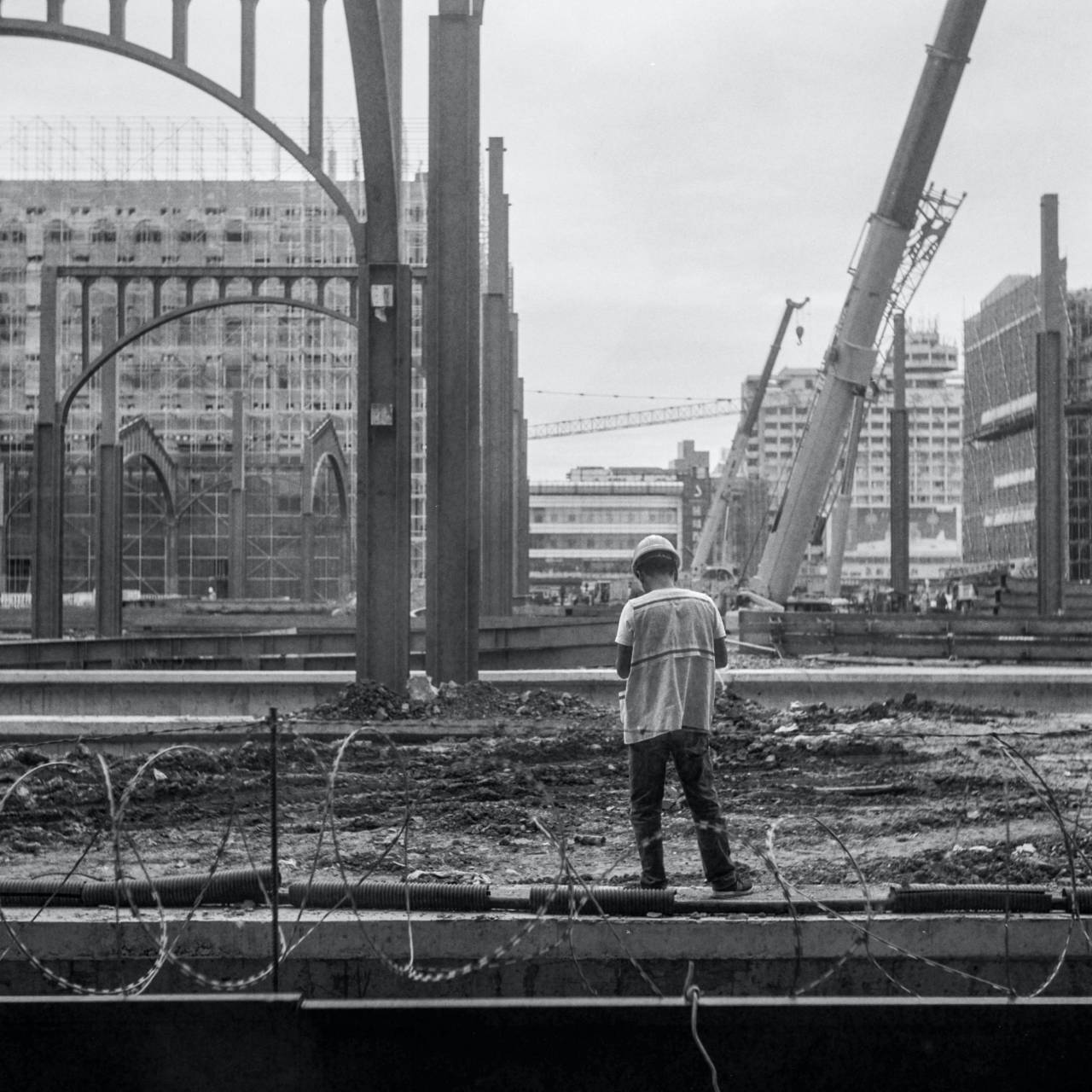 construction worker,men,black and white,construction industry,architecture,construction site,one person,outdoors,working,occupation,industry,engineer,hardhat, 