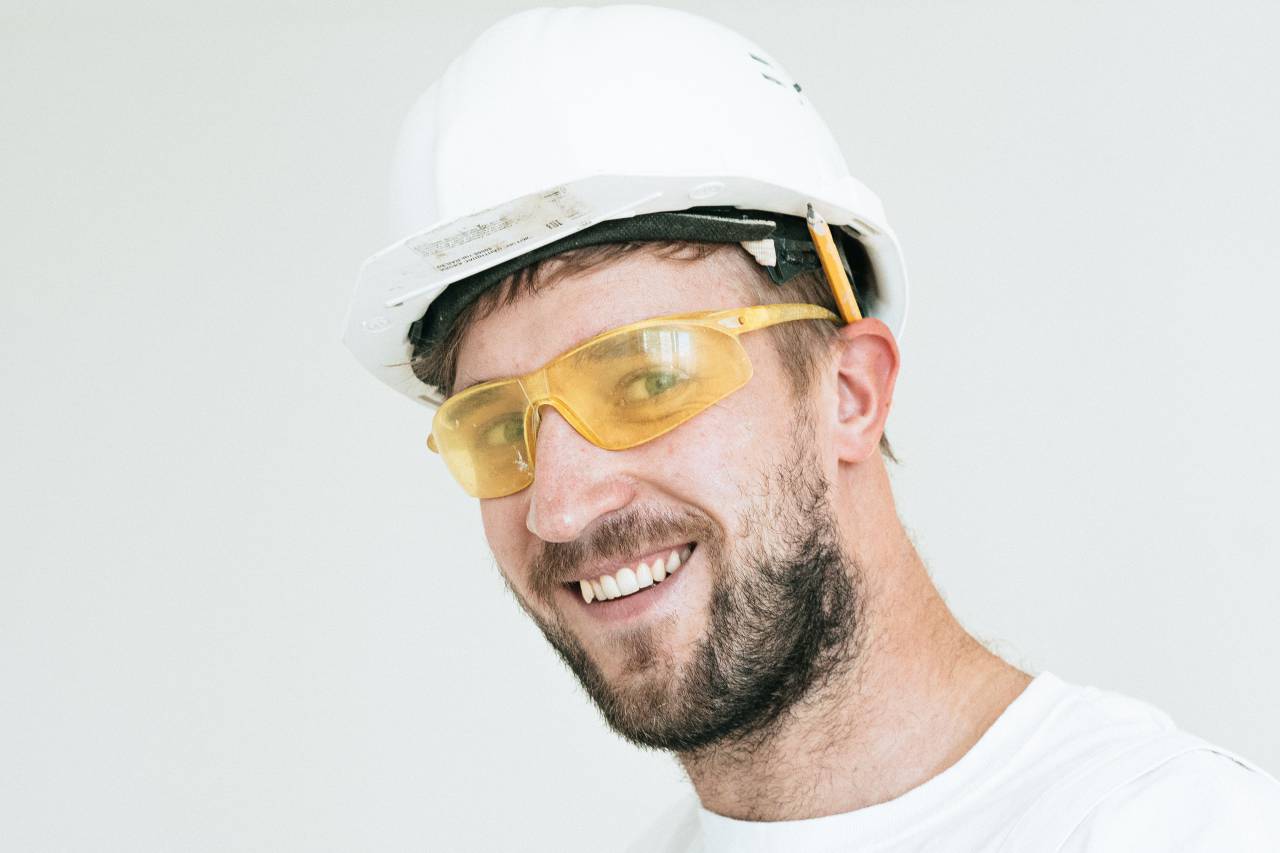 construction worker,men,males,one person,adult,caucasian ethnicity,hardhat,smiling,construction worker,work helmet,portrait,occupation,looking at camera,engineer,construction industry,working,beard,protective workwear,confidence,eyeglasses,one,man,industry,isolated,cheerful,protective eyewear,close-up,looking,safety, 