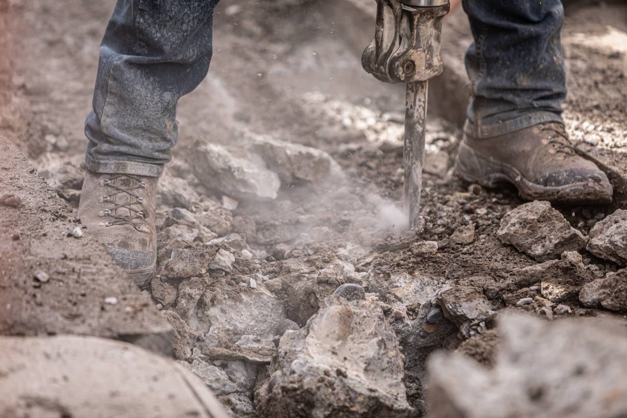 construction worker;drill;concrete,outdoors,shoe,men,nature,working,mud,dirty,dirt,close-up,human foot,boot,human leg,adult,one person, 