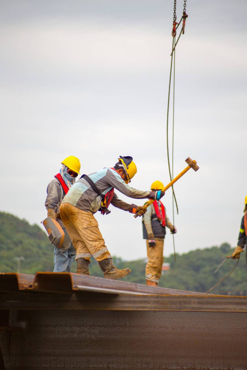 construction worker;hammer,outdoors,men,construction industry,occupation,working,construction site,hardhat,extreme sports,construction worker,industry,engineer,teamwork,adult,building,activity, 