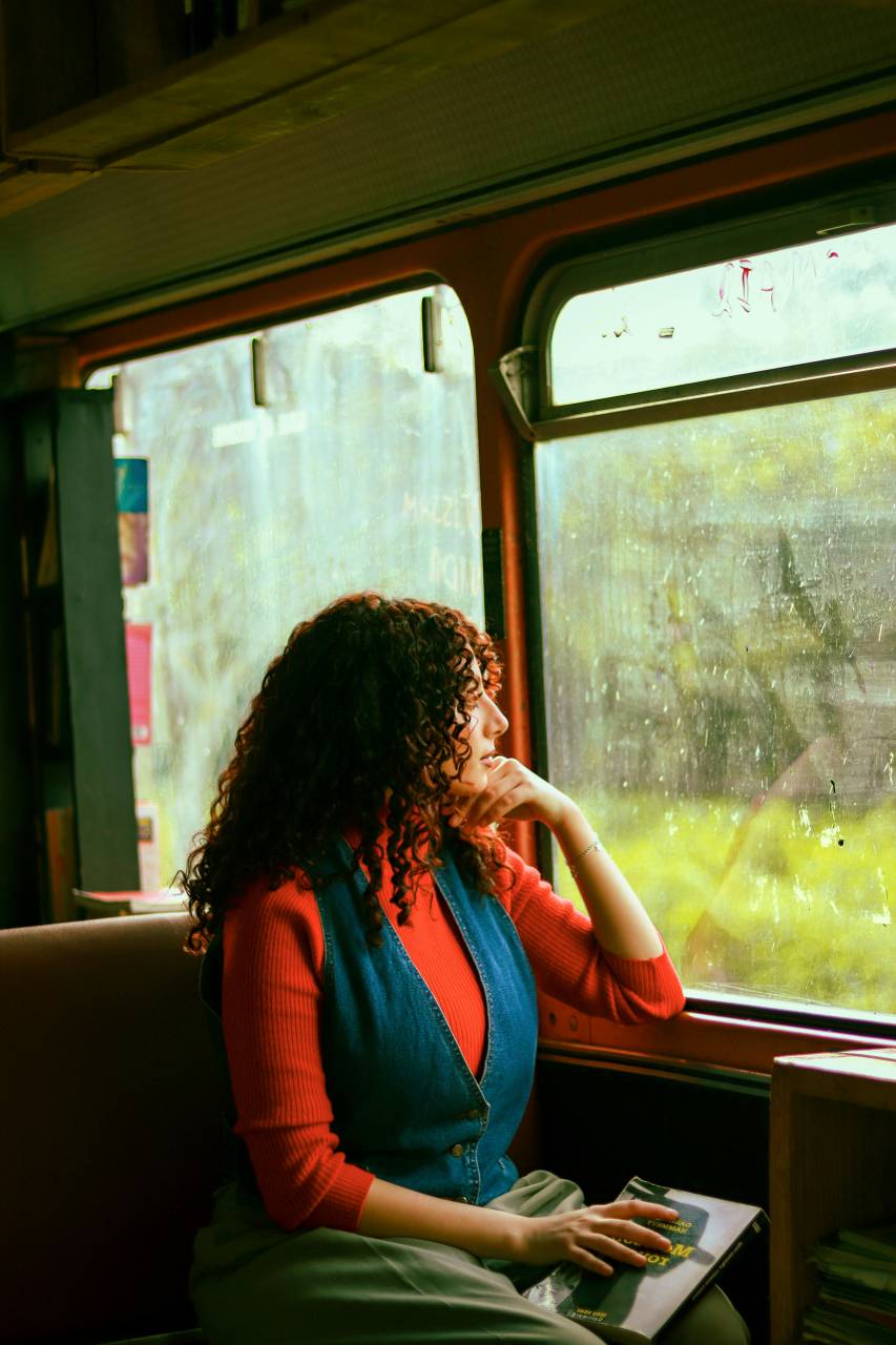 Adult, Woman, Train, Window, Rain, Book, Reflection, Thoughtful, Journey, Travel, Calm, Peaceful, Quiet, Reading, Nostalgia, Solitude, Contemplation, Perspective, Escape, Rainy, Cozy, Mood, Literature, Relaxation, Introspection, Scene, Commuting, Tranquility, Focus, Serenity, 