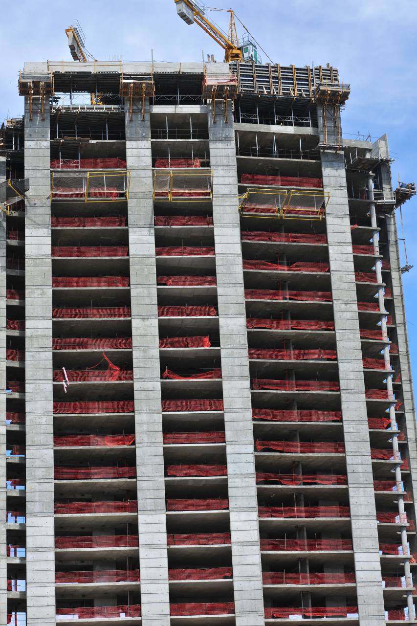 building;construction,construction site,architecture,construction industry,built structure,concrete,building exterior,building,activity,cement,engineering,crane,construction machinery,construction frame,scaffolding,development,housing development,industry,skyscraper,apartment,modern,home ownership,working, 