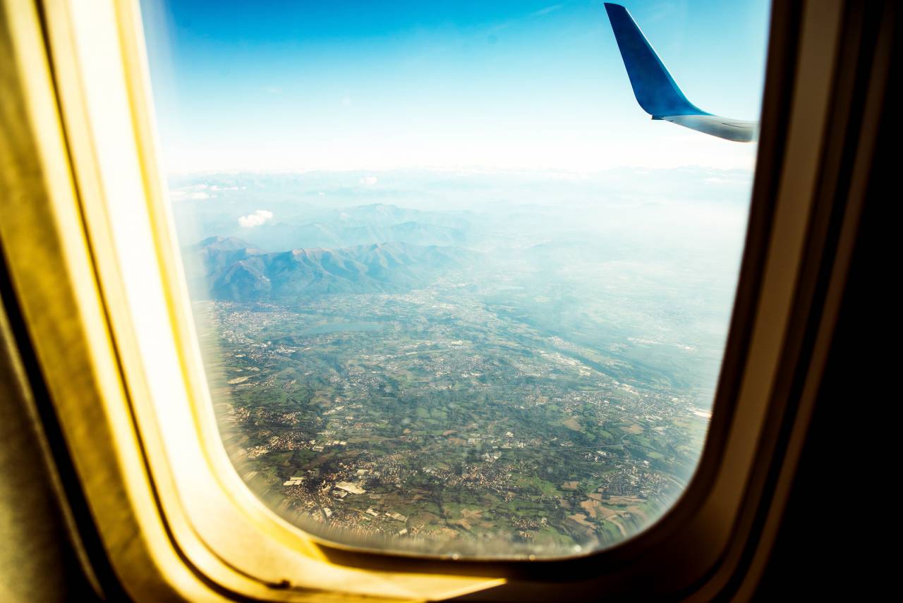 airplane;Window,airplane,flying,window,air vehicle,travel,transportation,aerial view,looking through window,blue,aircraft wing,nature,commercial airplane,cloud,sky,mode of transport,landscape,journey,vacations,high up, 