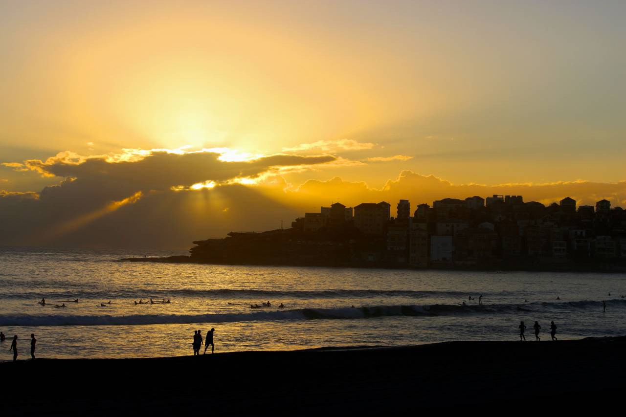 beach, sunset, silhouette, ocean, sea, sand, sun, recreation, landscape, nature, people, vacation, coast, buildings, dusk, waves
, 