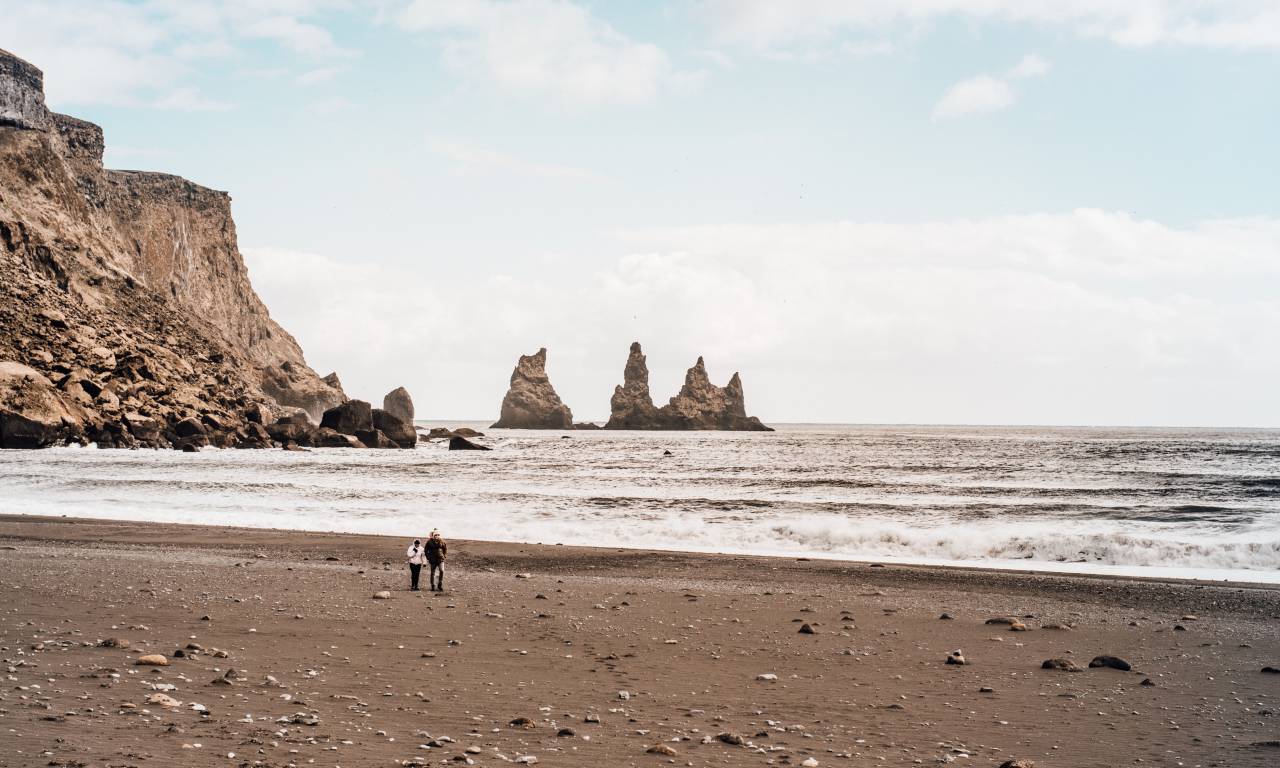 people, man, woman, vacation, beach, shore, coast, sea, water, ocean, waves, hill, mountain, sky, nature, rock, formation
, 