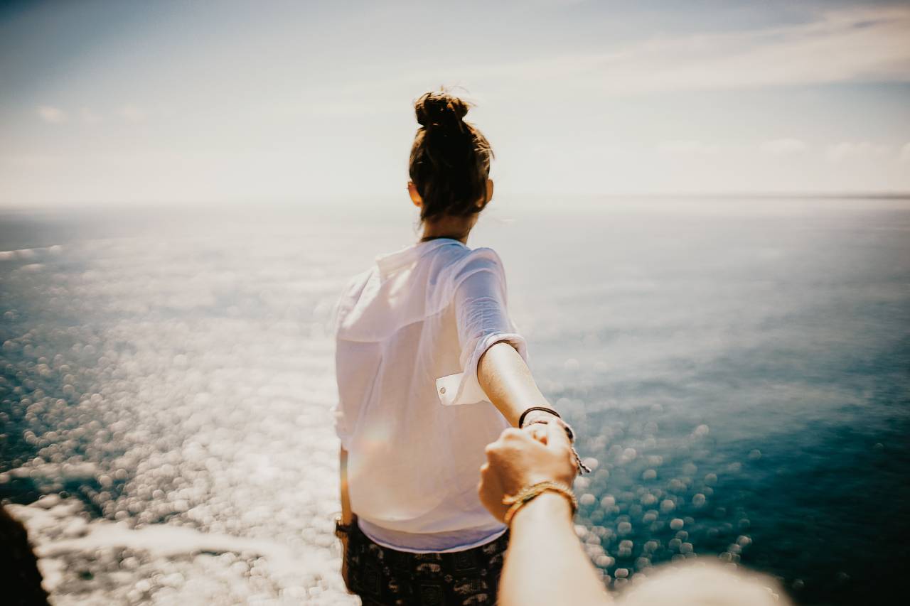 woman, adventure, beach, ocean, travel, explore, water, sea, shore, sky, outdoors, nature, holding, hands, walking, sunny, clouds, waves, female, person, summer
, 