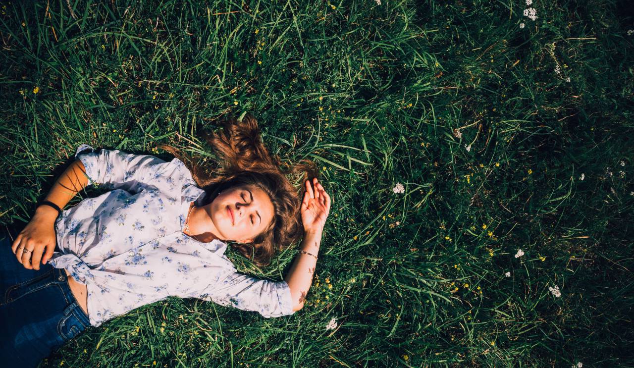 Woman, Eyes closed, Lying, Outdoors, Relaxing, Nature, Tranquility, Serene, Restful, Peaceful, Leisure, Calm, Closed eyes, Outdoor lifestyle, Daydreaming, Meditation, Fresh air, Beauty, Natural setting, Reclining, Contentment, Horizontal, Harmony, Sunlight, Outdoor relaxation, flowers, field, 