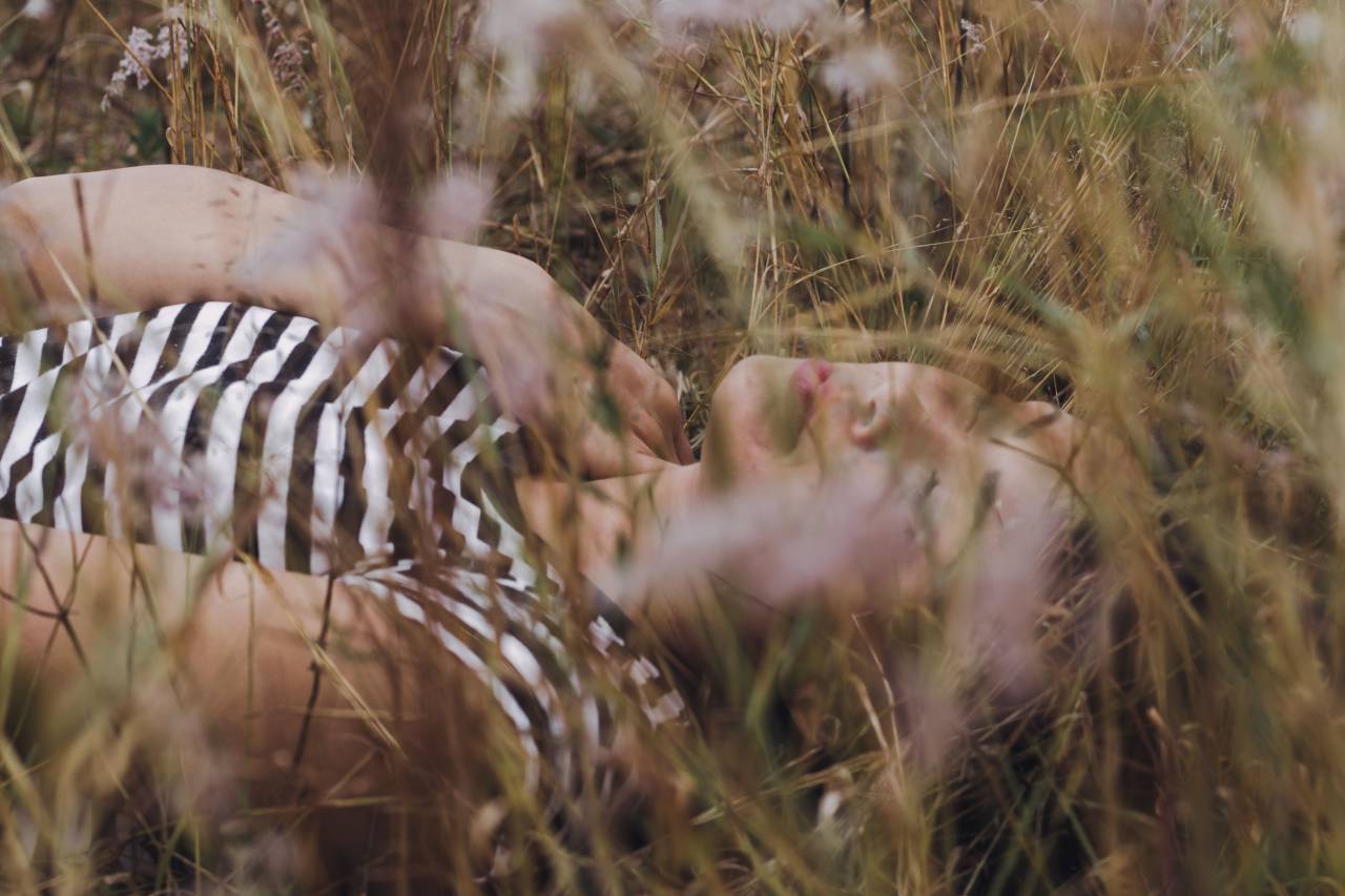 Woman, Eyes closed, Lying, Outdoors, Relaxing, Nature, Tranquility, Serene, Restful, Peaceful, Leisure, Calm, Closed eyes, Outdoor lifestyle, Daydreaming, Meditation, Fresh air, Beauty, Natural setting, Reclining, Contentment, Horizontal, Harmony, Sunlight, Outdoor relaxation, flowers, field, 