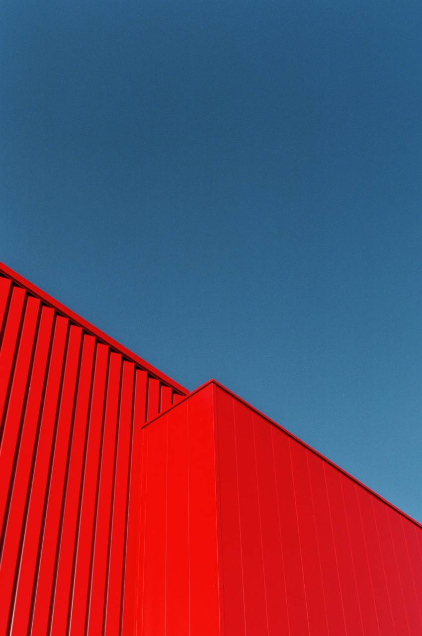 container;cargo;red;sky,blue,architecture,steel,backgrounds,metal,outdoors,construction industry,industry,building exterior,abstract,built structure, 
