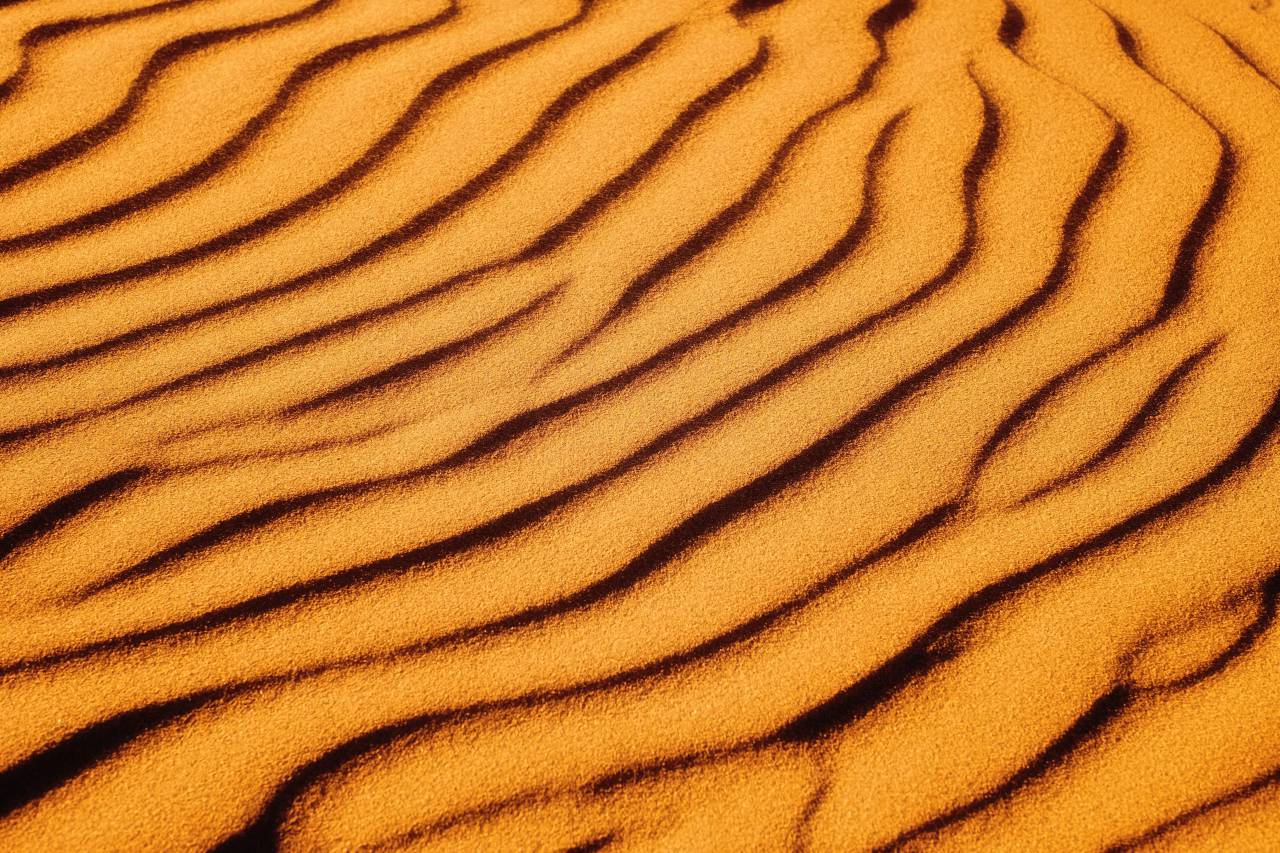 orange color;background;desert, arid, lines, wind, background, sand, texture, copy space, no people, full frame, 