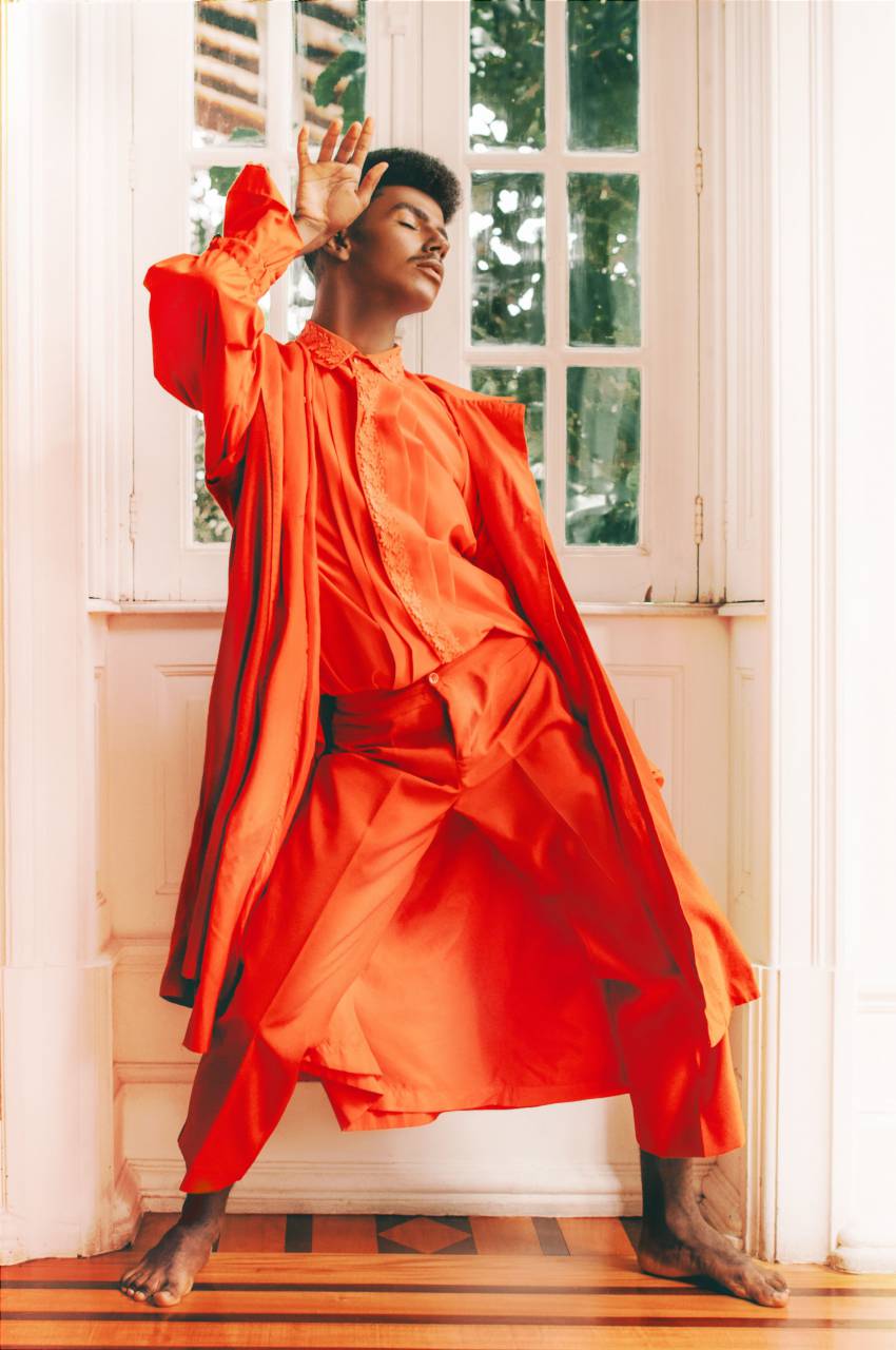 orange color;background;man, fashion, modern, model, posing, interior, studio shot, dreaming, window, 