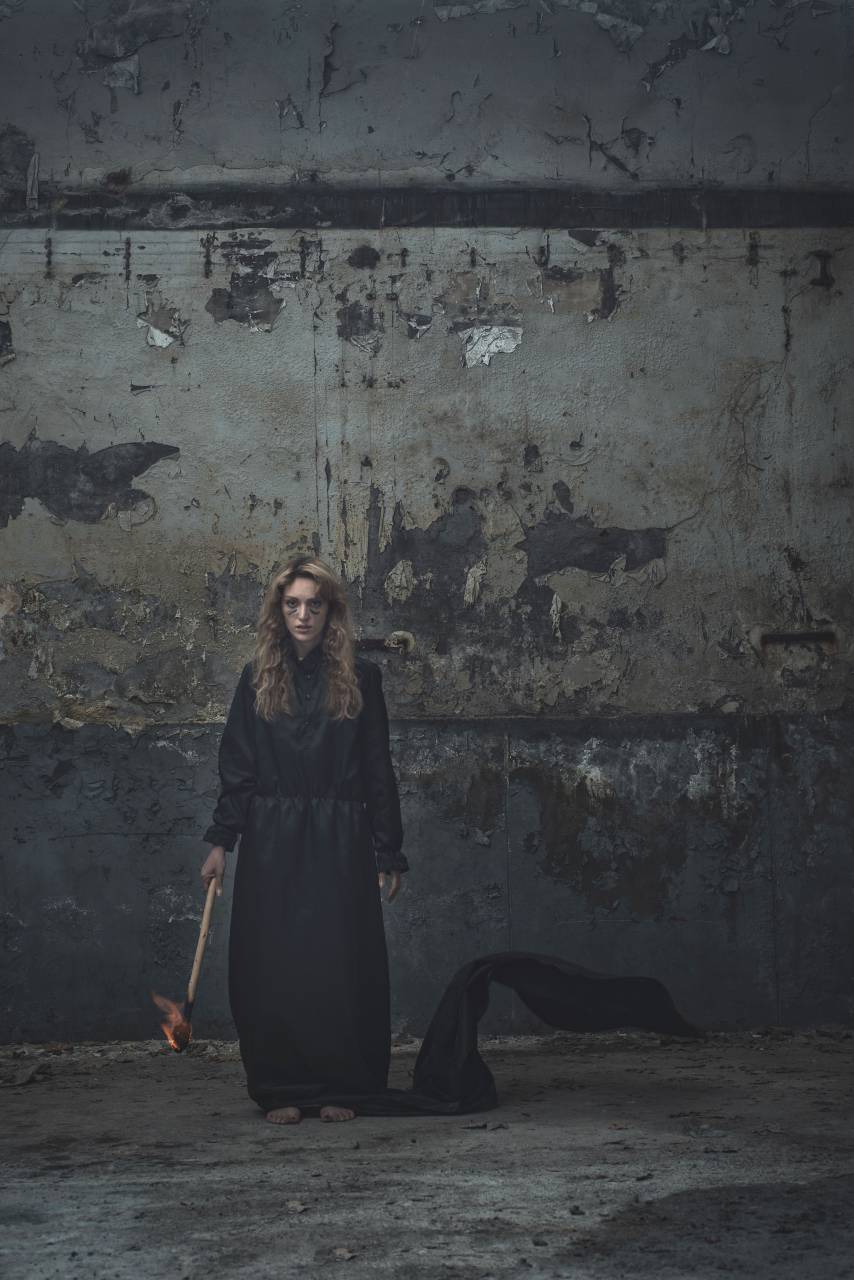 people, woman, black, clothing, torch, dark, fire, outside, wall
, 