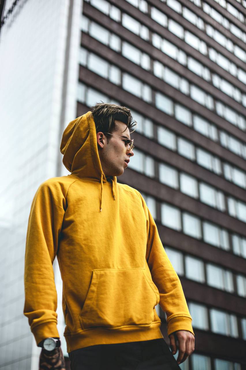 Man, wearing, yellow, hoodie, outdoors, city, one person, 